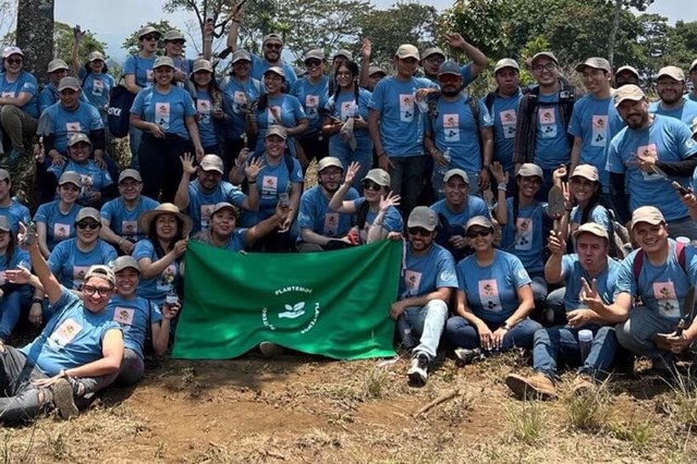 Colaboradores de una empresa con la bandera de Plantemos al terminar su jornada